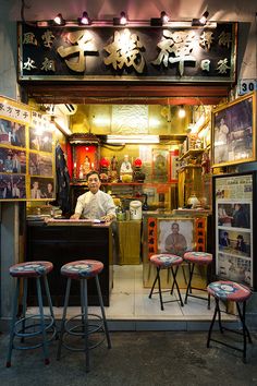 a man sitting at a counter in front of a restaurant