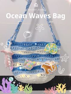 a crocheted purse hanging from the side of a wall with ocean waves on it