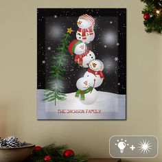 a christmas card with three snowmen and a tree