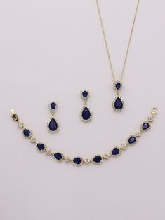 "Add a touch of sparkle and these classically designed framed blue sapphire colored cubic zirconia teardrop wedding earrings, necklace and bracelet set that dangle with sparkle. Measuring 1 1/4\" long, these are perfect for any special occasion. Necklace measures 16\"-18\" (adjustable). Optional bracelet measures 7\" long. Choose from silver, gold or rose gold. All jewelry features high quality electroplating that does not fade or chip and is nickel free (hypoallergenic). Orders are shipped via Blue Sapphire Drop Jewelry, Blue Gold Plated Jewelry For Party, Gold And Blue Bracelet, Sapphire Crystal Drop Jewelry, Sapphire Jewelry With Sparkling Stones For Wedding, Elegant Sapphire Drop Jewelry, Sapphire Cubic Zirconia Jewelry For Wedding, Teardrop Sapphire Jewelry, Sapphire Cubic Zirconia Wedding Jewelry