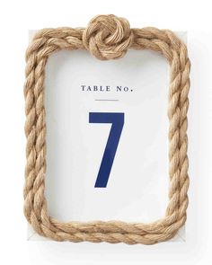 a rope frame with the number seven on it and an ad for table no 7