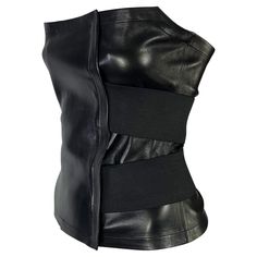 Presenting a stunning leather bandage strap Yves Saint Laurent Rive Gauche bustier top, designed by Tom Ford. From the Spring/Summer 2001 collection, many similar strap designs debuted on the season's runway. This ultra sleek and sexy corset is constructed entirely of leather that wraps around the body and is secured with elastic bands. Never before worn, this top is made complete with the original store tags still attached! Approximate measurements: Size - FR34 33.5" bust 28.5" waist 14.75" fro Elegant Punk Fashion, Leather Fitted Corset For Evening, Fitted Leather Corset For Evening, Black Leather Evening Corset, Leather Tops, Luxury Corset For Night Out, Top Bustier, Costume National, Underbust Corset