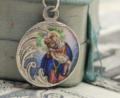 A magnificent antique silver enamel Pieta medal, petite Austrian enamel amulet on a 16 inch long sterling chain, rare Virgin Mary Catholic charm, very nicely done, in good condition, ideal for strength and protection necklace, would make a nice gift for someone special! Comes with approx. 16 inch long 925 silver necklace (see photo 5)! Material: solid silver, enamel total weight: 6.6g Measures: approx. 22 mm (0.8 inch) in diameter A stunning religious jewelry shop well worth a visit ... https:// Antique Miraculous Medal Pendant Jewelry, Antique Miraculous Medal Necklace As Gift, Victorian Jewelry With Miraculous Medal For Gifts, Victorian Enamel Medallion Necklaces, Enamel Medallion Necklace With Hallmark, Vintage Nickel-free Enamel Necklaces, Collectible Jewelry With Miraculous Medal Round Pendant, Collectible Miraculous Medal Round Pendant, Collectible Round Miraculous Medal Jewelry