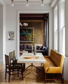 a magazine cover with a table and chairs in front of a window that reads down town