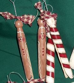 three christmas decorations made to look like hot dogs and candy canes on a green background