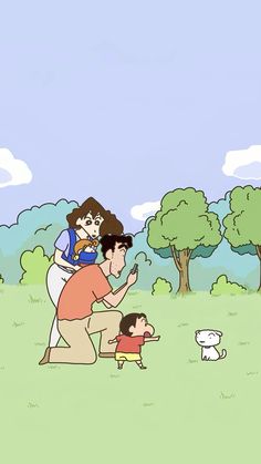 a man and woman are playing with a child in the park