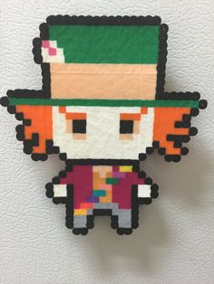 the pixel art is made from paper and has an image of a person wearing a green hat