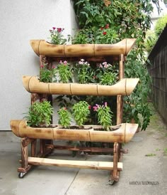 a planter made out of bamboo sticks and plants