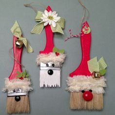 three red and white christmas decorations hanging on a wall