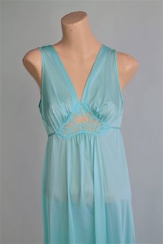 "Beautiful mint, pale green lingerie gown by LORRAINE in a size Small. Perfect honeymoon lingerie with Peekaboo Fitted Bodice Waist and V neckline. This Lingerie Mirrors Full sweep Olga Lingerie in style. by Lorraine size Small please follow measurements for desired fit: measurements laying flat: armpit to armpit up to 18\" under bust up to 17.5\" waist up to 21\" hip up to 23.5\" top shoulder to bottom hem line 53.5\" Fabric: nylon tricot made in USA Excellent vintage condition **Moviestarmoon Sheer Sleeveless Green Sleepwear, Green Sheer Sleeveless Sleepwear, Green Camisole For Bedtime, Green Peekaboo, 1970s Clothing, Perfect Honeymoon, Lingerie Gown, Green Lingerie, Honeymoon Lingerie