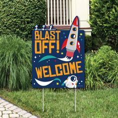 a welcome sign in front of a house with a rocket ship on it and the words blast off welcome