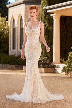 a woman in a wedding dress standing outside