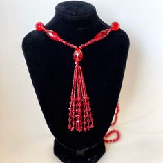 Beautiful, shimmering ruby red glass (likely crystal) beaded sautoir necklace. Art Deco era. A sautoir is a French term for a long necklace that suspends a tassel or other ornament. This amazing vintage collectible will add drama to a dress, tunic or even a t-shirt & jeans. In excellent vintage condition. No chips or imperfections. Necklace approximately 38" long, tassel is 4" long. Evening Costume Jewelry Necklace With Faceted Beads, Elegant Red Long Necklace With Round Beads, Vintage Red Necklace For Celebration, Red Vintage Necklace For Celebration, Adjustable Faceted Beads Necklace For Evening, Vintage Red Necklace With Dangling Beads, Vintage Red Beaded Necklaces For Party, Red Vintage Necklace With Dangling Beads, Red Beaded Long Necklace For Gift