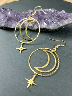 Gold Crescent Earrings With Moon Phase Detail, Gold Moon Shaped Metal Hoop Earrings, Gold Moon Shaped Hoop Earrings, Gold Moon Phase Earrings, Gold Moon-shaped Metal Hoop Earrings, Gold Hoop Jewelry With Moon Phase Detail, Gold Moon-shaped Earrings With Moon Charm, Moon Charm Hoop Earrings In Celestial Style, Celestial Metal Hoop Earrings Nickel Free