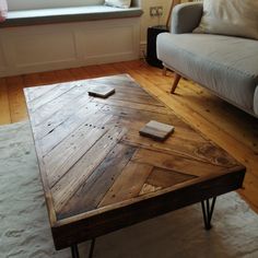 a living room with a couch, coffee table and window