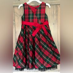 Absolutely Gorgeous Plaid Taffeta Christmas Holiday Dress By George. Girl's Size 8, Sleeveless With Crossover-Look Bodice. Full Gathered Skirt With Tulle Ruffled Underskirt For Added Fullness. Wide Red Grosgrain Ribbon Sash (Removable) Ties In Bow At Waist. Zipper Close Back. New And Never Worn. Received As A Gift And Was Tucked Away In A Closet And Unfortunately Was Outgrown Before It Was Able To Be Worn. Armpit To Armpit Measures 14.5 Inches. Top Of Shoulder To Bottom Hem Of Skirt 30 Inches. F Dress Christmas, Taffeta Dress, Holiday Dress, Gathered Skirt, Christmas Dress, Holiday Dresses, Grosgrain Ribbon, Kids' Dresses, Crossover