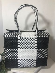 "Vintage black and white plastic woven tote purse, Vintage plaid pattern box style woven handbag purse, Vintage beach tote, Vtg vacation bag.  This bag has two large snaps at the top and fold over closure and is unlined. Height 8.5\" Width 11\" Depth 6\" Straps 21\"" White Woven Handheld Straw Bag, Woven Rectangular Shoulder Bag For Picnic, Handheld White Woven Straw Bag, White Square Straw Bag For Daily Use, White Rectangular Straw Bag For Vacation, White Square Straw Bag With Handles, White Handheld Woven Straw Bag, Rectangular Woven Beach Bag, White Rectangular Straw Bag With Handles