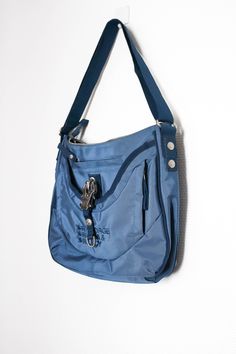 Blue George Gina & Lucy bag with adjustable strap (can be worn as a crossbody or on the shoulder). This item is preloved but in 9/10 condition with only light scratches on the hardware.  Bag dimensions: 32 x 28 x 8cm (12.5" x 11" x 3") Strap drop: 27-57cm (10.5" - 22") Blue Travel Shoulder Bag With Zipper Closure, Blue Shoulder Bag With Zipper For Travel, Blue Shoulder Bag With Zipper Closure For Travel, Blue School Shoulder Bag With Adjustable Strap, Functional Blue Bags With Detachable Strap, Functional Blue Bag With Adjustable Strap, Blue Backpack Shoulder Bag With Zipper Pocket, Blue Shoulder Bag With Zipper Pocket, Functional Blue Crossbody Shoulder Bag