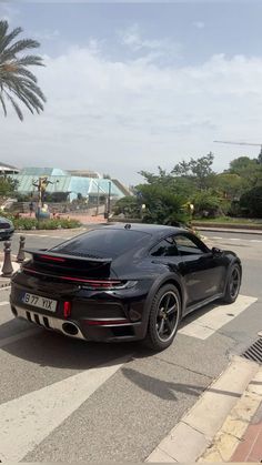 a black sports car is parked on the street