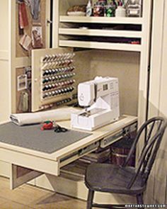 a sewing machine sitting on top of a wooden table next to a chair and cabinet