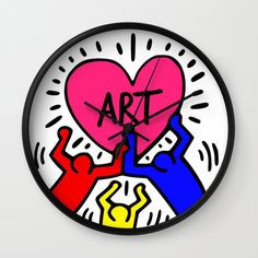 a clock with the word art on it and two hands holding a heart in front of it