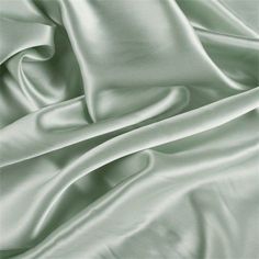 a close up view of a satin fabric with very soft folds and smooth lines on it