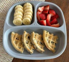 four different types of food in a plastic container on a table with strawberries, bananas and chocolate chips