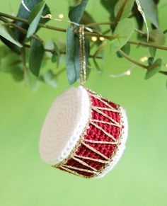 a red and white ornament hanging from a tree