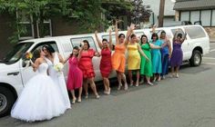 a group of bridesmaids standing in front of a white truck with their arms up