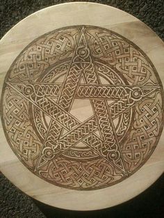 a wooden plate with an intricate design on it