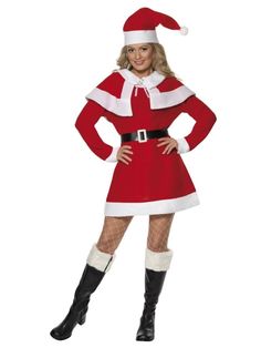 a woman dressed as santa clause posing for the camera with her hands on her hips