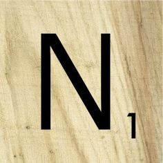 the letter n is made out of wood and has black letters on it's sides