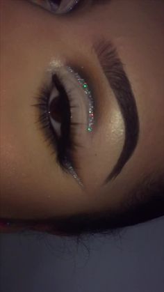 a woman's eye with long lashes and glitters