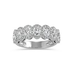 a white gold ring with five diamonds on the sides and four rows of round stones in the middle