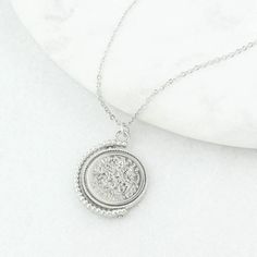 "A lucky sixpence spinner necklace displaying a genuine polished 1962 sixpence coin. Featuring a genuine 1962 sixpence coin, this vintage inspired necklace makes for a memorable and thoughtful gift for anyone celebrating a 60 year milestone. NOTE: the images show 1960 sixpence but you will receive a 1962 coin. The sixpence is traditionally given as a symbol of good luck so would make a fantastic gift for a wedding, birthday or any other special occasion. It is something that can be worn and kept Classic Silver Necklace With Vintage Charm, Silver Classic Necklace With Vintage Charm, Silver Necklace With Vintage Charm, Anniversary Coin Necklace Nickel Free, Classic Charm Necklace With Coin Medallion, Classic Charm Necklaces With Coin Pendant, Silver Initial Pendant Medallion Necklace, Tarnish Resistant, Classic Charm Necklaces With Coin Medallion Pendant, Classic Silver Necklace With Coin Pendant