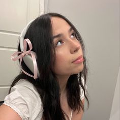 a woman with long hair wearing headphones