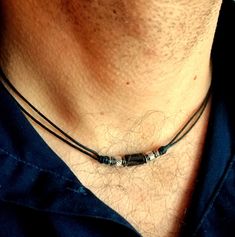 A stylish and laconic choker necklace for men with a faceted black onyx stone bead and stainless steel elements on a thin black cotton cord, stainless steel lobster claw closure. Delicate necklace with natural onyx stone will suit as a casual choker necklace for him. Minimalist surfer style bead cord necklace will be a great gift for him. Necklace length: personalized Black onyx bead: 8 x 5 mm For all products are used only genuine high-quality Italian leather, natural stones and wood. All metal Rope Necklace Men, Male Necklace Diy, Men Leather Necklace, Chokers For Men, Handmade Necklaces For Men, Masculine Jewelry For Men, Necklace Designs Men, Manly Necklace, Men Jewelry Aesthetic