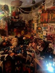 a bed room with a neatly made bed and many pictures on the wall