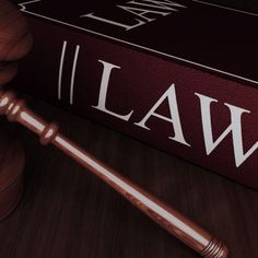 a judge's gavel sitting on top of a law book