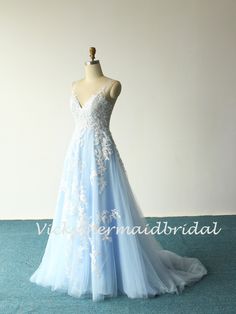 a light blue wedding dress with white flowers on it