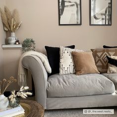 a living room filled with furniture and pictures on the wall