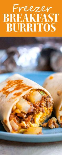 a burrito cut in half on a blue plate with the words freezer breakfast burritos