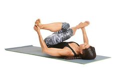 a woman is doing a yoga pose on a mat