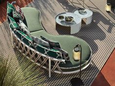 an outdoor seating area with chairs, tables and lamps on the ground near plants in pots