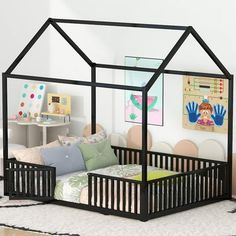 a child's bed with a black frame and canopy