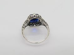 Vintage Sterling Silver Blue Sapphire Filigree Ring ....Marked 925...Total of weights 2.3grams...Size 8...Measure of Face 14.7MM...It's in very good condition. Blue Filigree Ring Hallmarked For Anniversary, Vintage Blue Jewelry With Halo Setting, Vintage Blue Halo Setting Jewelry, Sterling Silver Ring With Intricate Blue Design, Blue Ring With Intricate Design Fine Jewelry, Sterling Silver Rings With Intricate Blue Design, Blue Sterling Silver Rings With Intricate Design, Sterling Silver Rings With Intricate Design In Blue, Collectible Blue Sapphire Ring Hallmarked