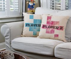 two pillows on a white couch in front of a window with shutters and a pirate figurine