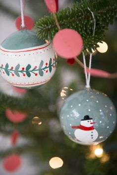 ornaments hanging from a christmas tree decorated with snowmen