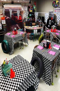 tables and chairs covered in checkered cloths are set up for a race themed party