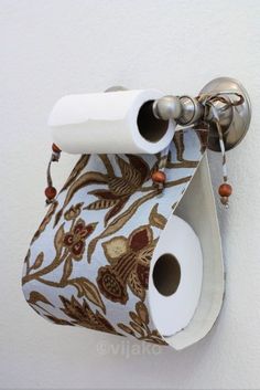 the toilet paper holder has two rolls of toilet paper hanging from it's side